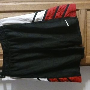 Nike basketball shorts dri fit size small black with red and white on side.
